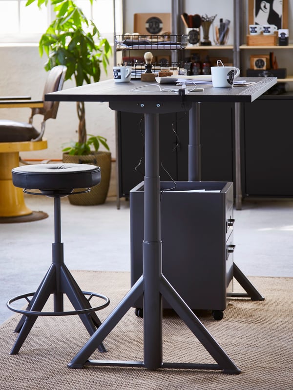 A dark grey IDÅSEN drawer unit on castors in the home office