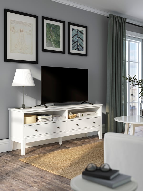 A white IDANÄS TV bench with a LOHALS rug on the floor.
