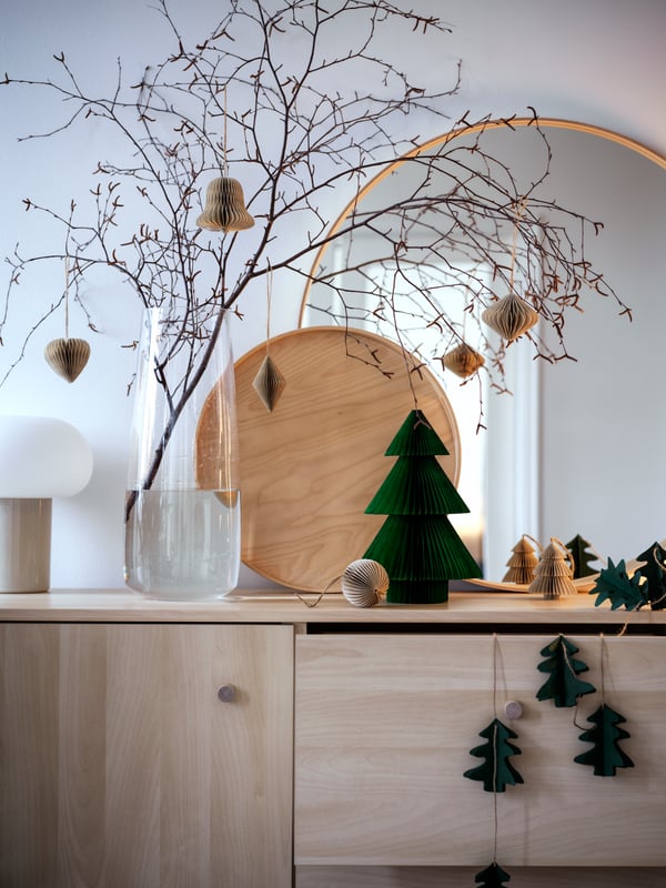 Branches and twigs are arranged in the vase BERÄKNA. Everything is decorated and decorated for Christmas on ERSNÄS sideboard.