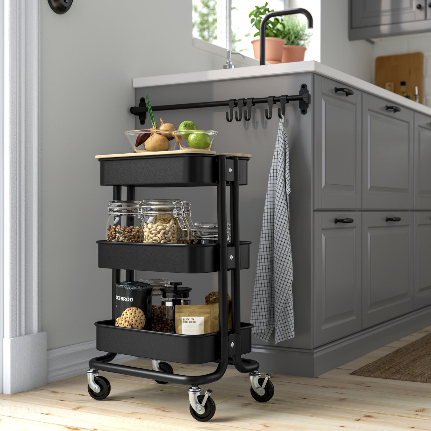 A black RÅSKOG trolley in the kitchen