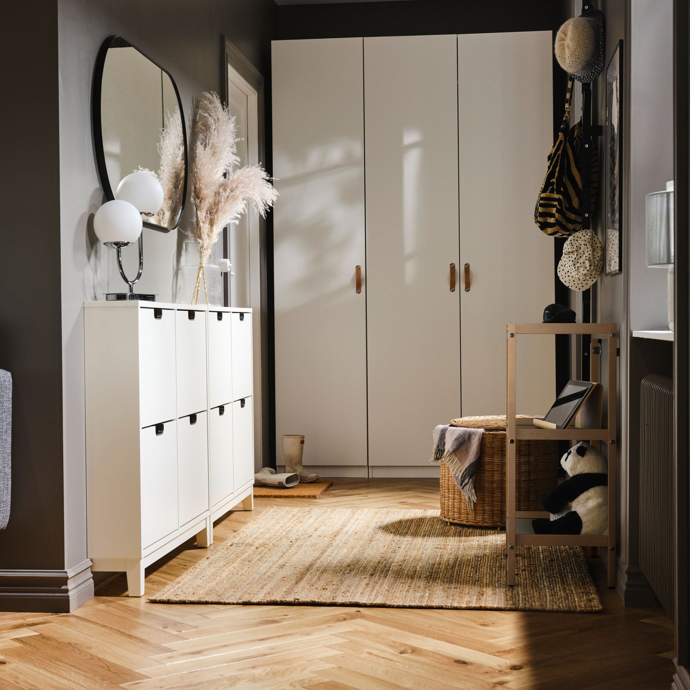 A white STÄLL shoe cabinet with 4 compartments in the hallway