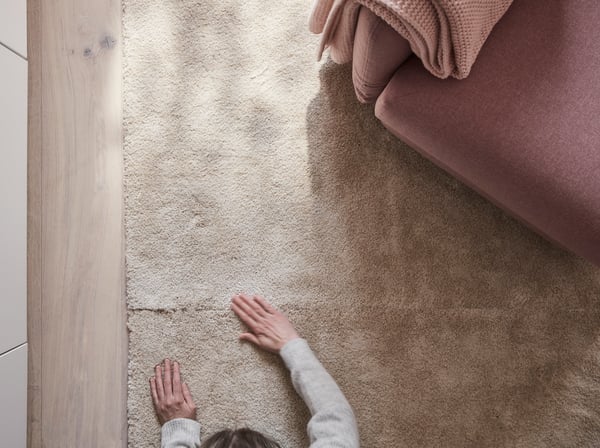 An off-white STOENSE rug, low pile in the living room