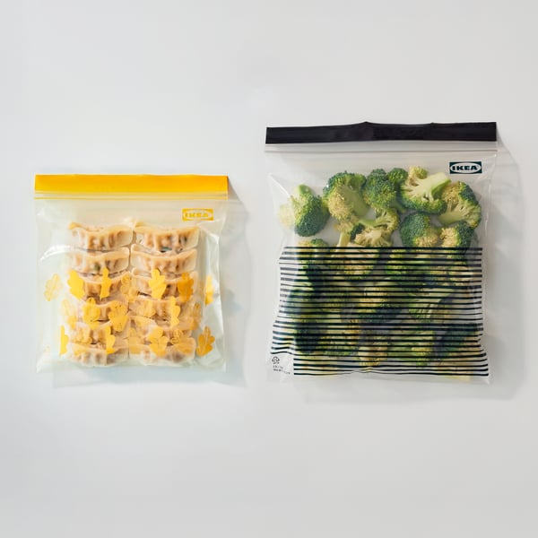 IKEA resealable bags with a yellow zipper holding baked snacks and a black zipper holding broccoli.