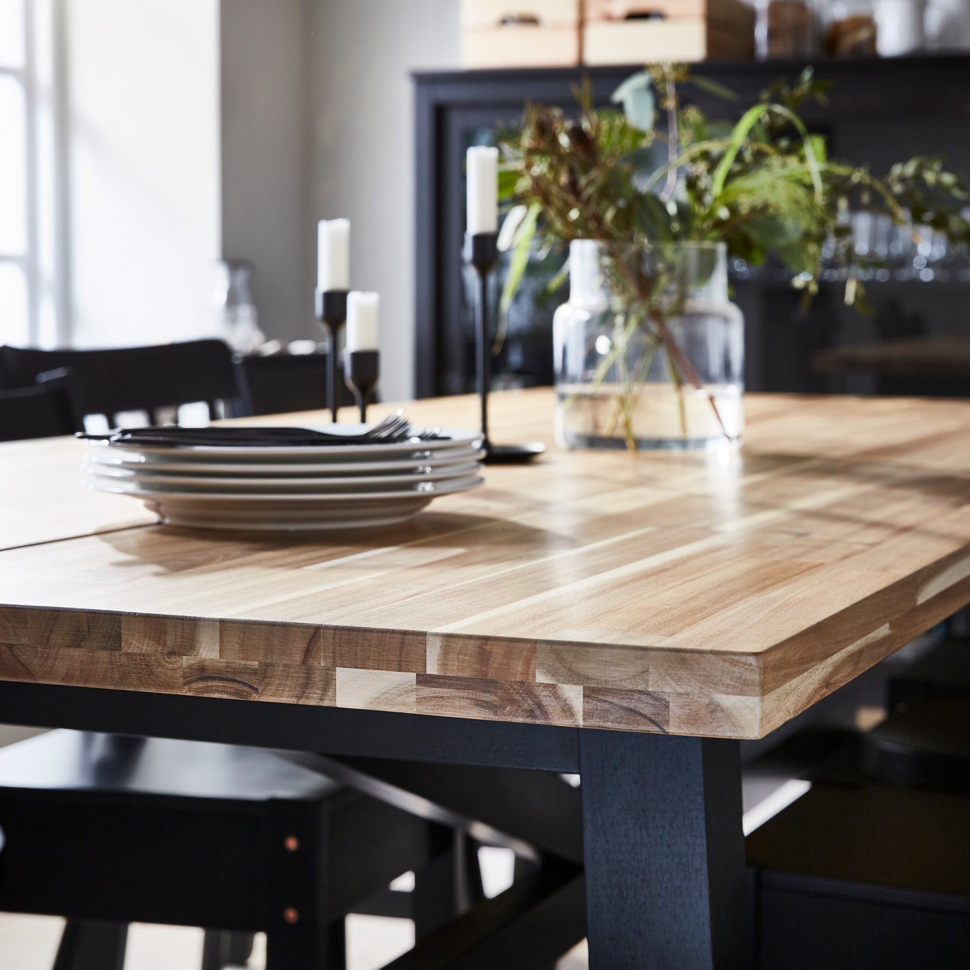 An acacia/black SKOGSTA dining table in the dining room