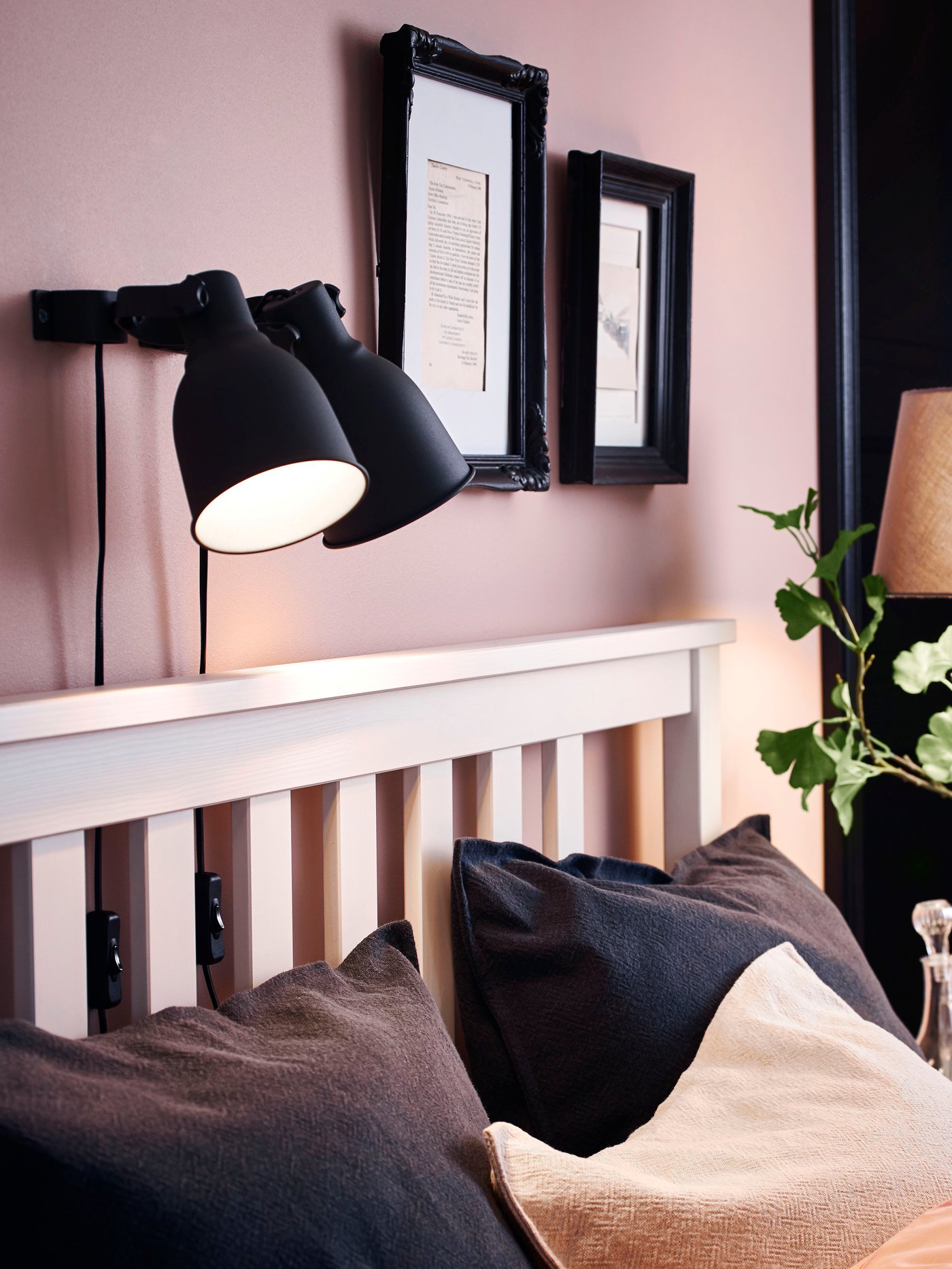 A dark blue-grey JOFRID cushion cover in the bedroom