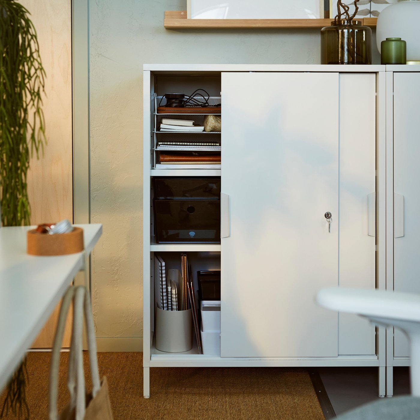A white TROTTEN cabinet with sliding doors