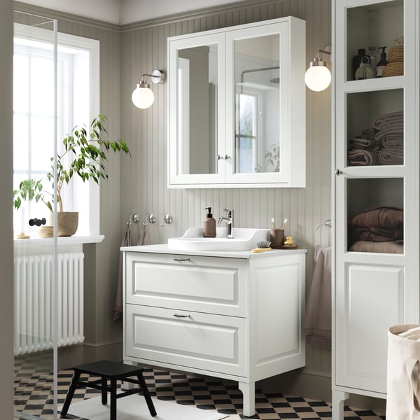 A white TÄNNFORSEN set with a wash-stand with drawers, a RUTSJÖN semi-recessed wash-basin and a mirror cabinet.