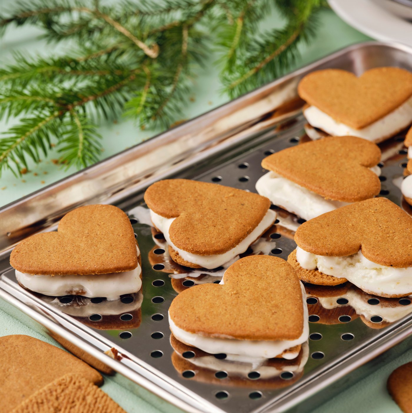 Seven gingerbread ice cream sandwiches on a silver tray.