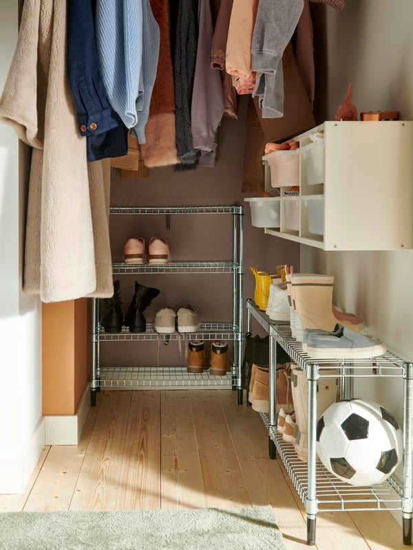 The top of the open wire shelf of the OMAR shelving unit showing each shelf holding different-sized white bowls.
