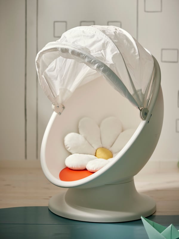 IKEA PS LÖMSK swivel armchair with a hood that can be pulled down for privacy. SKOGSDUVA cushion that looks like a flower.