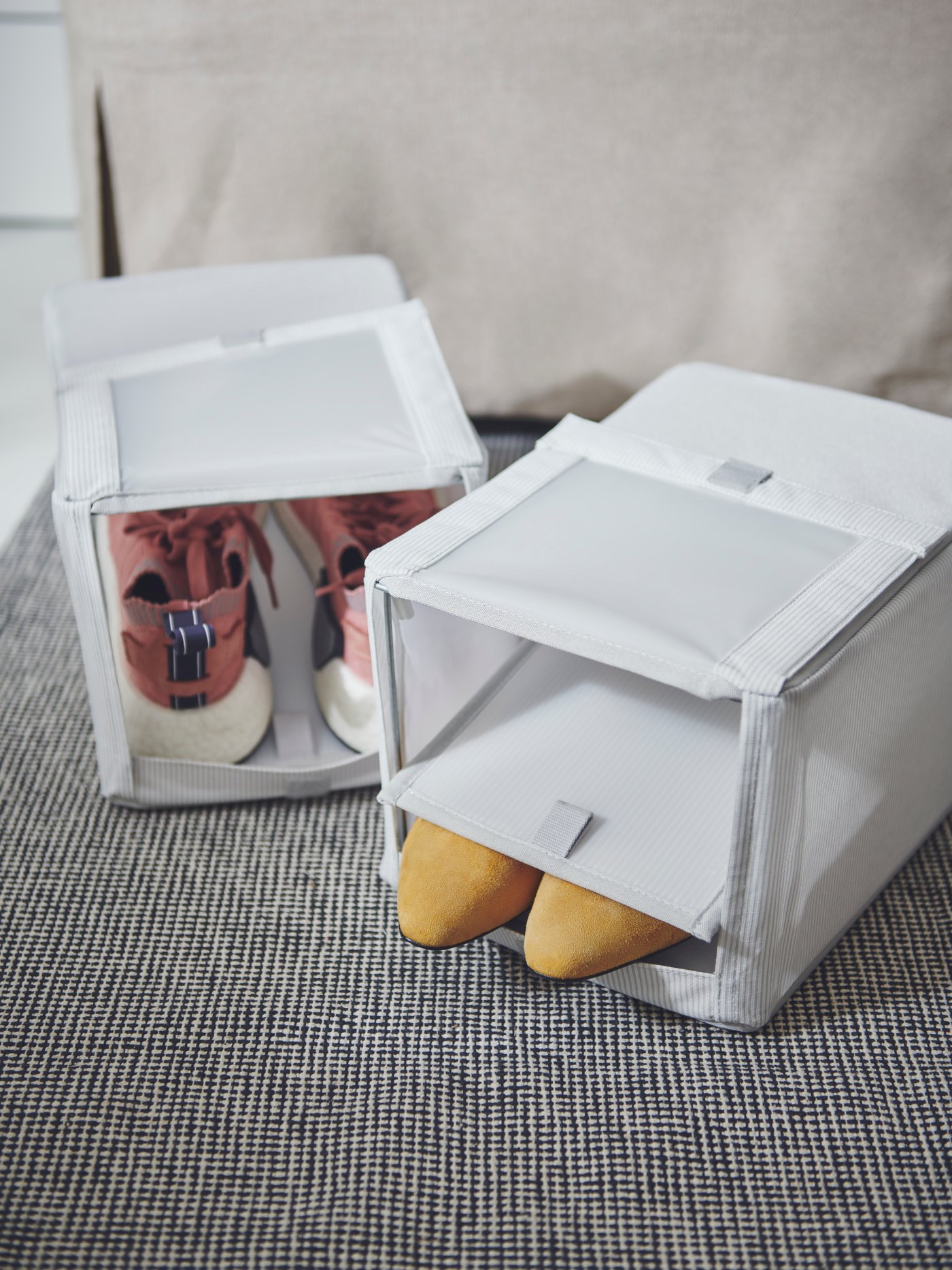 Two white shoe boxes with sneakers in one box and yellow flats in another