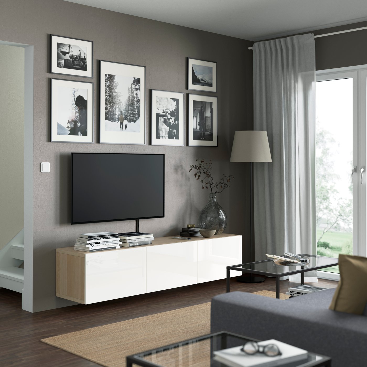 A white stained oak effect/Selsviken high-gloss/white BESTÅ TV bench with doors in the living room