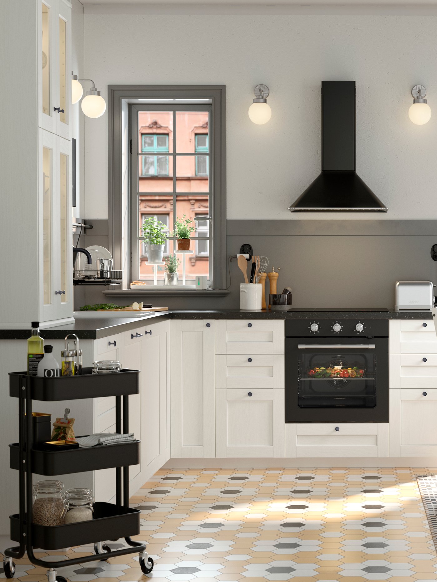 A stainless steel colour FRIHULT wall lamp in the kitchen
