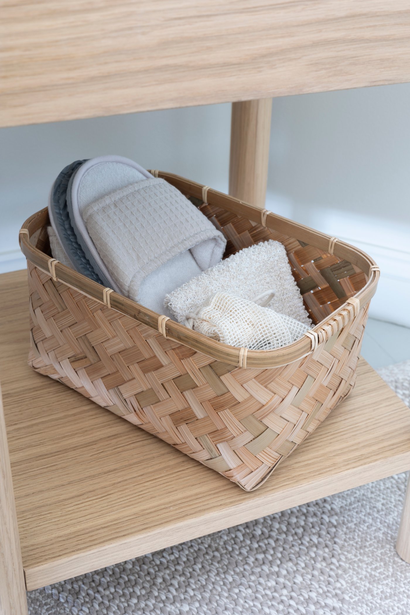 An oak veneer TONSTAD bedside table in the bathroom