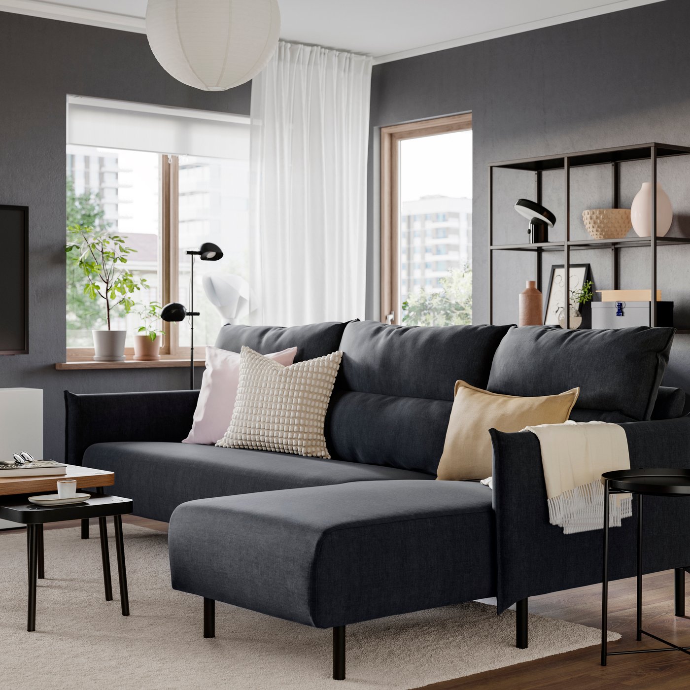 A dark MANNARP sofa in the living room.