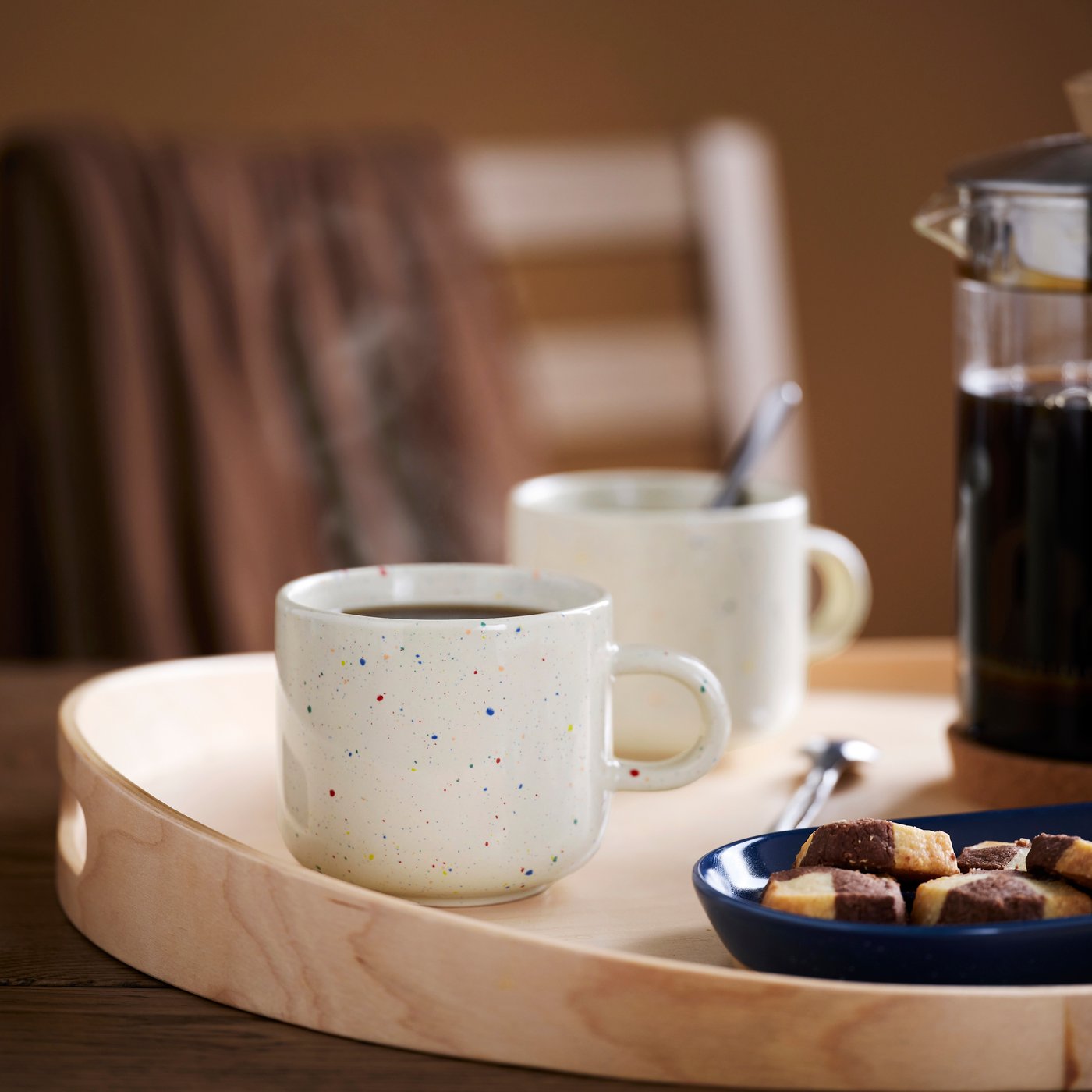 Gesprenkelte Tasse auf einem OMBONAD Holztablett.