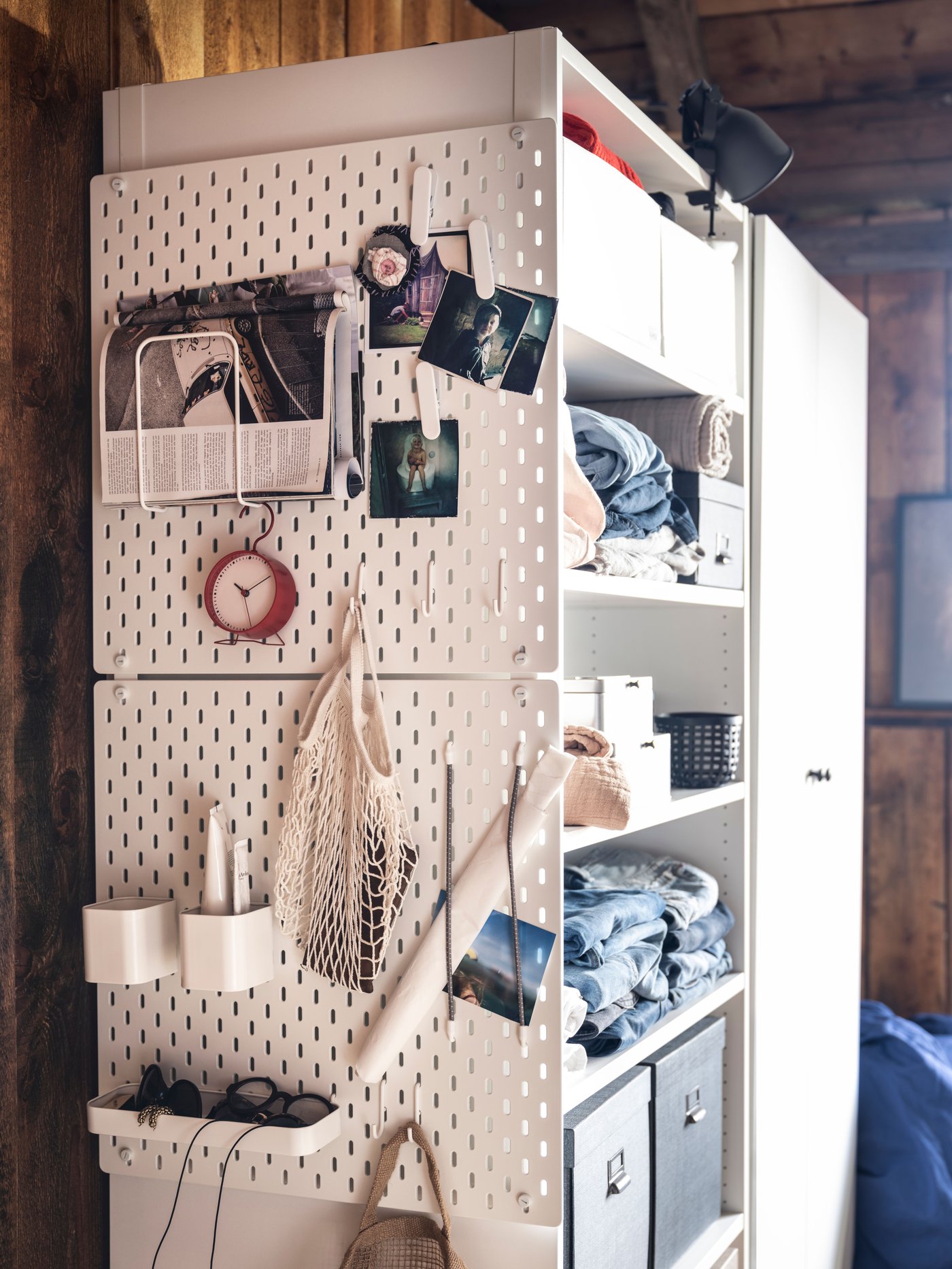 A white SKÅDIS pegboard in the bedroom