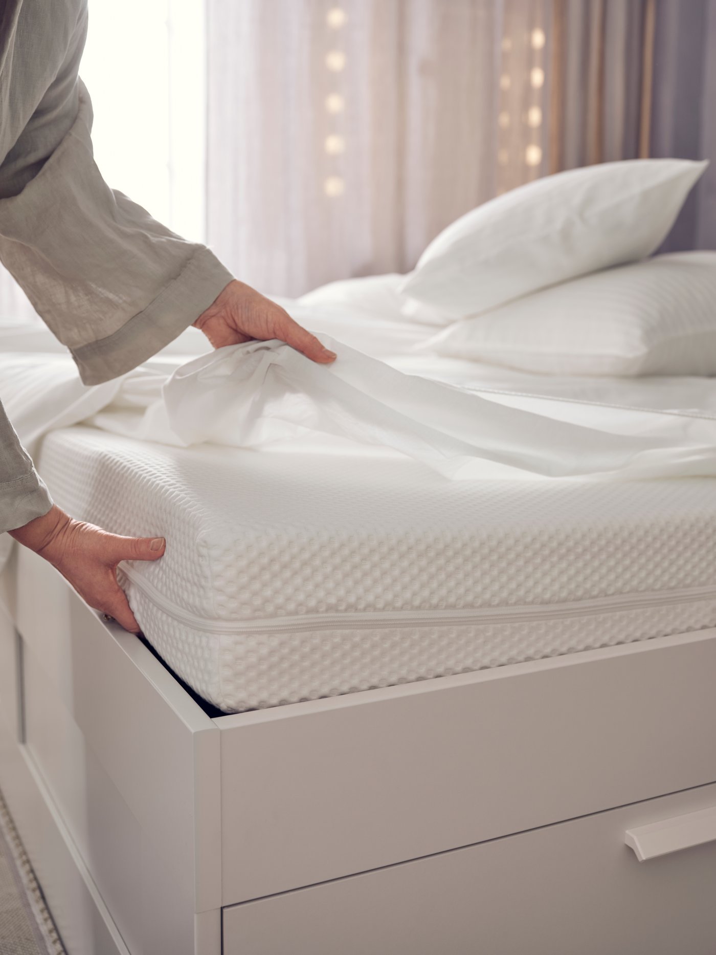 A firm/white ÅBYGDA foam mattress