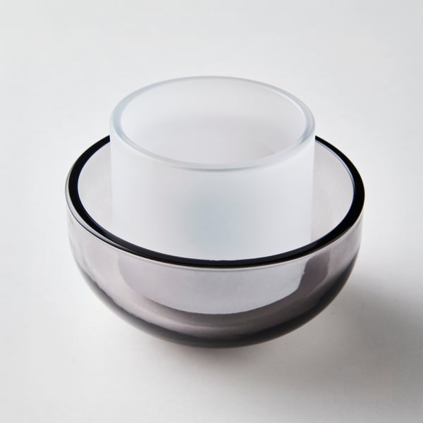 A TALLTITA tealight holder, the smaller frosted-glass part standing in the wider, bowl-shaped, grey clear-glass outer part.