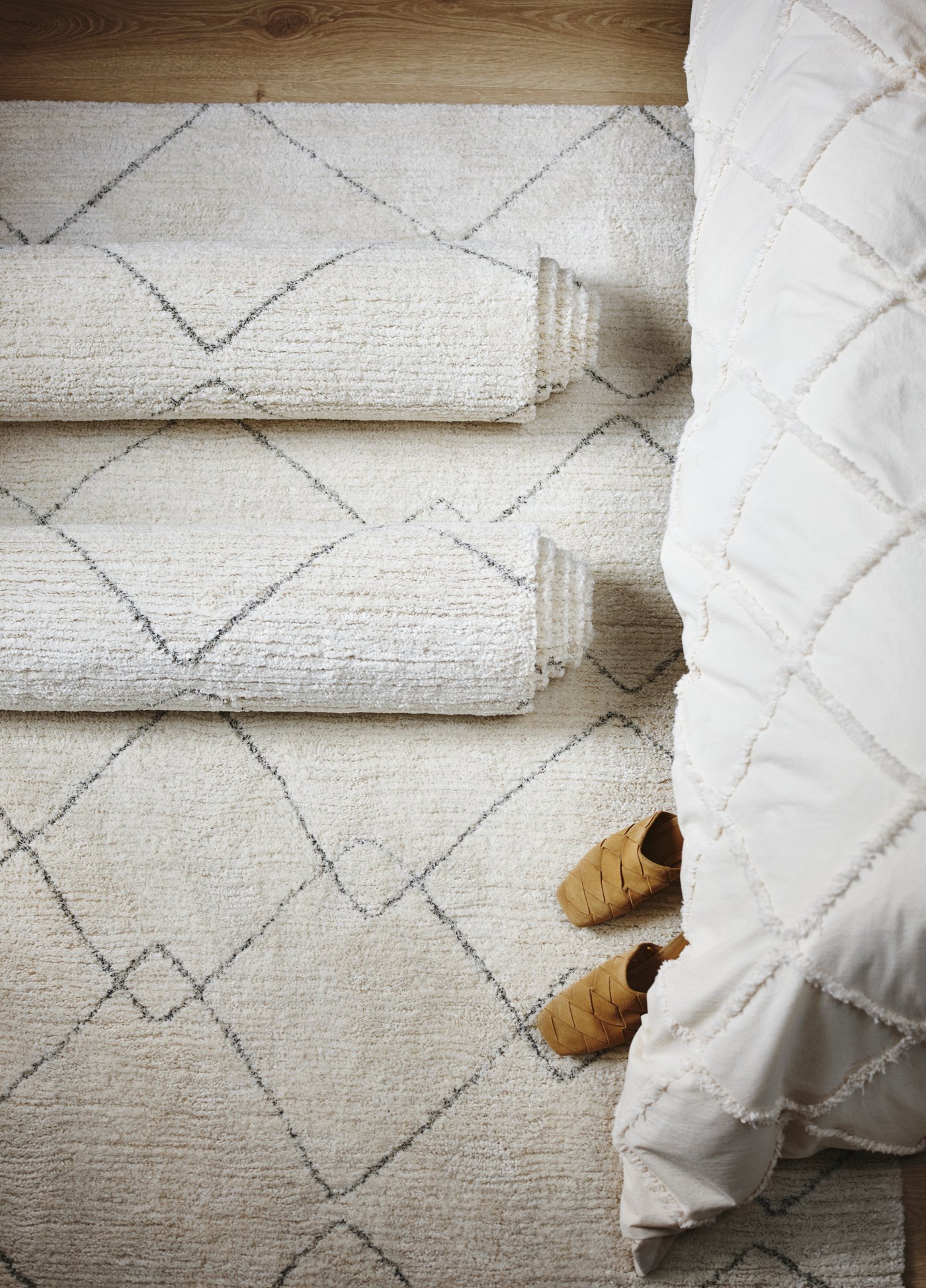 A beige TVERSTED rug, low pile in the bedroom