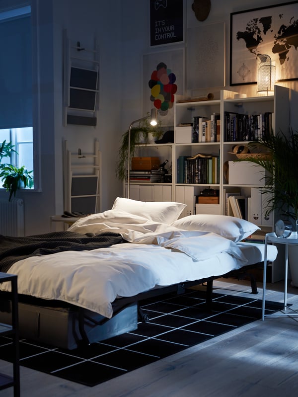 A white BAGGEBO bookcase in the bedroom