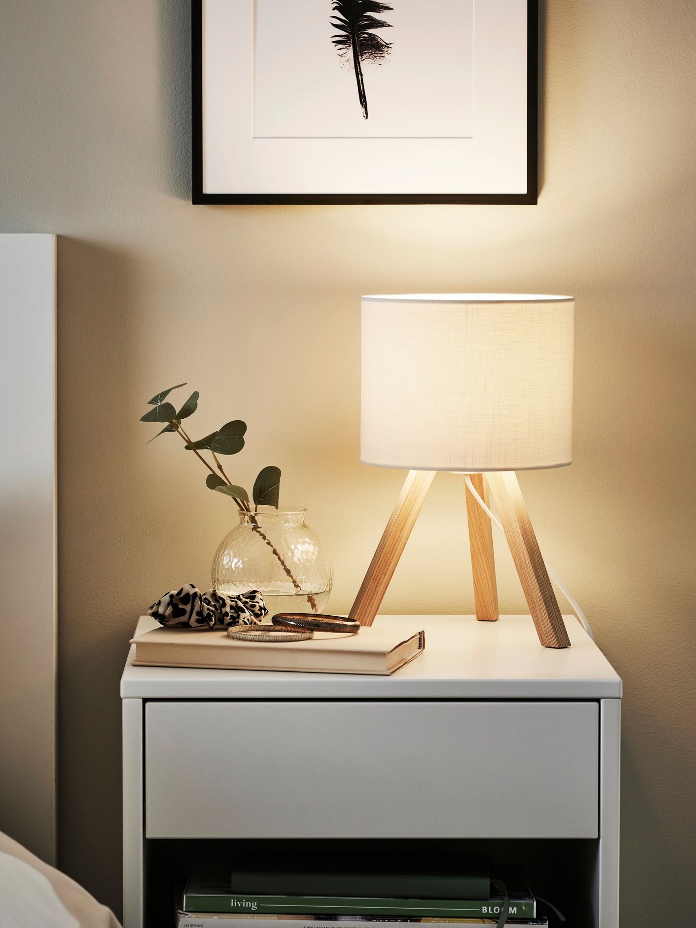 An ash/white STORSEGEL table lamp in the bedroom