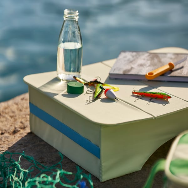 A pale green STRANDÖN tray table, in/outdoor