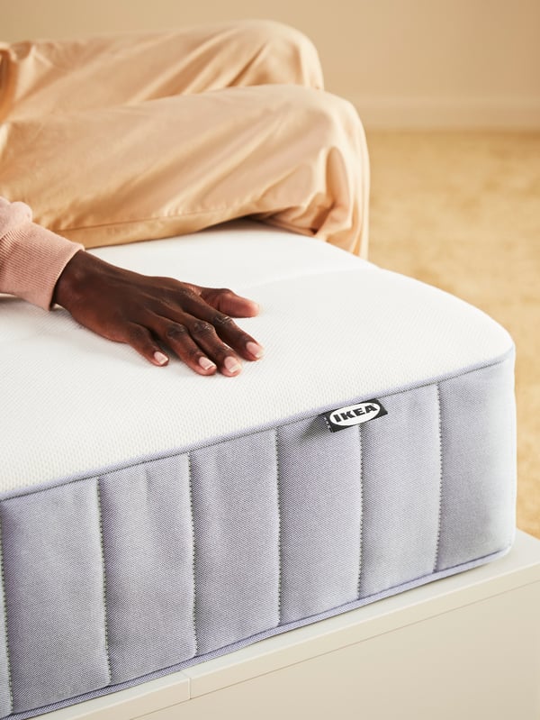 A firm/light blue VESTERÖY pocket sprung mattress