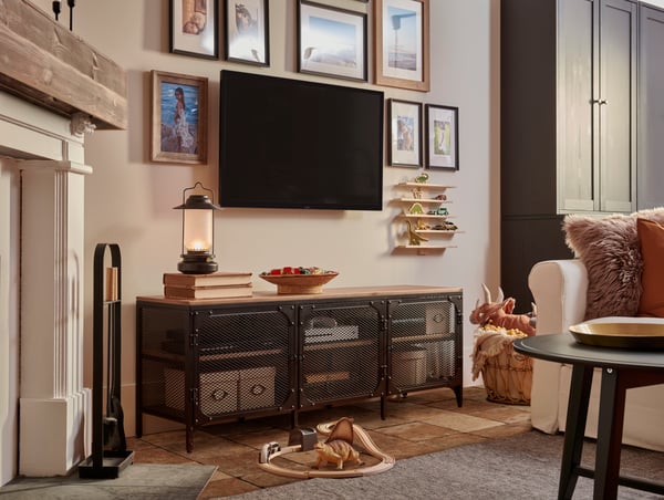 A black FJÄLLBO TV bench in the living room