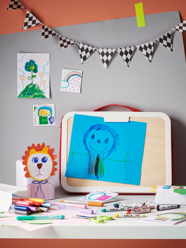 Maleta para dibujar MÅLA con un dibujo sobrepuesto en un papel azul.