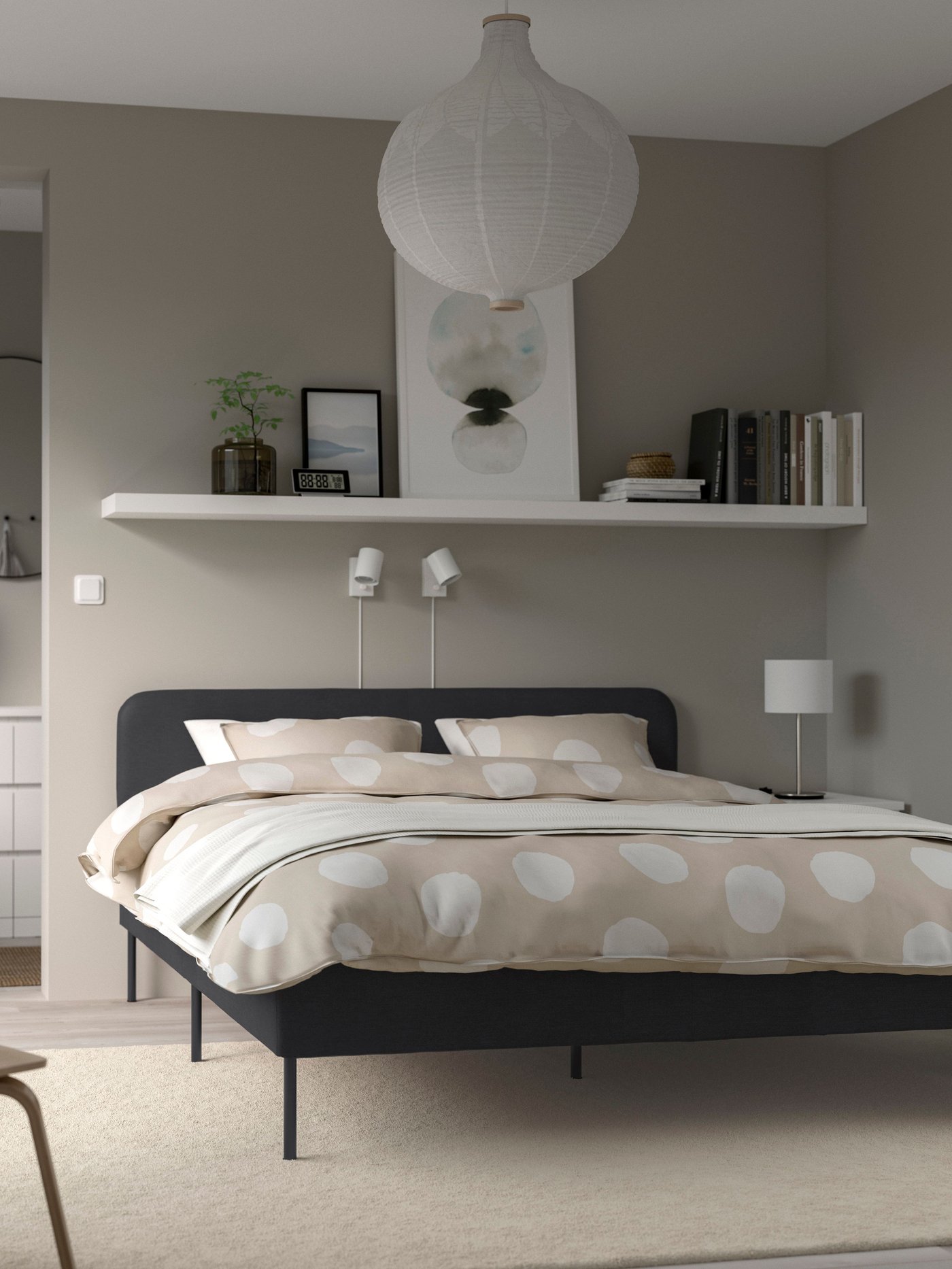 A Vissle dark grey SLATTUM upholstered bed frame in the bedroom