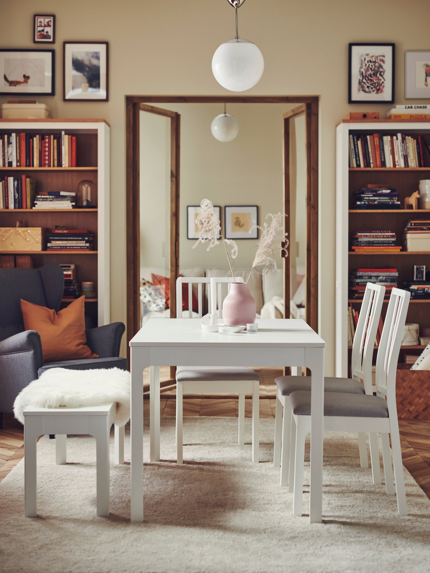 White dining table with chairs and bench
