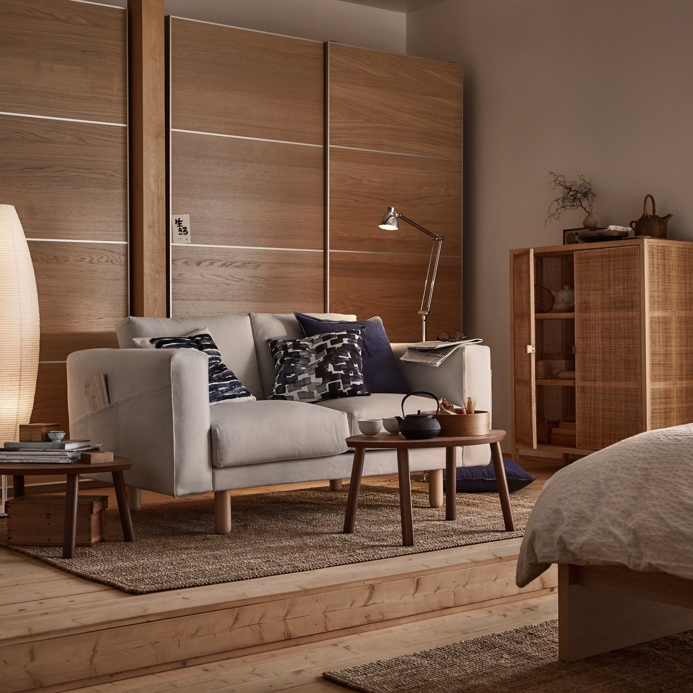 A walnut veneer STOCKHOLM nest of tables in the living room