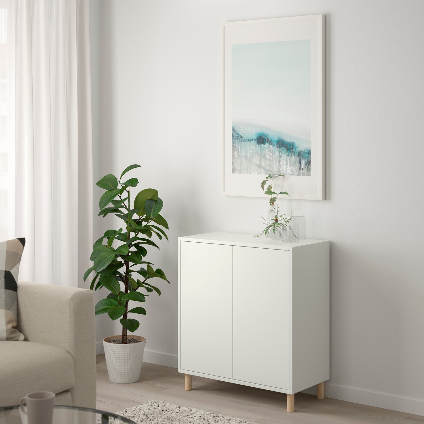 A white/wood EKET cabinet combination with legs