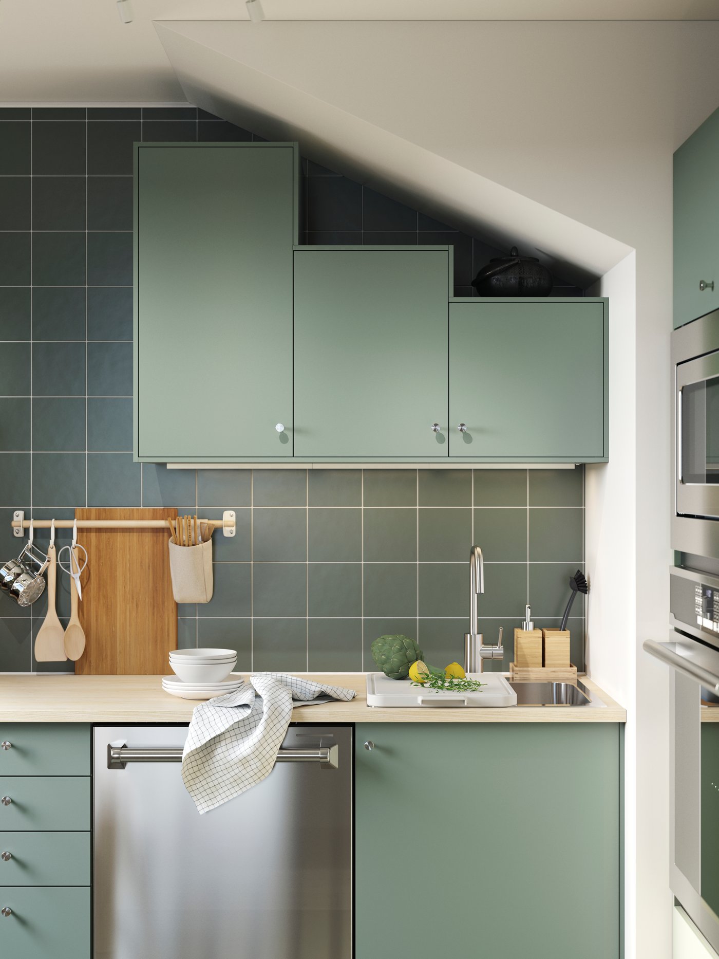 A green-tiled kitchen has cabinets with grey-green NICKEBO fronts, a green-striped rug and a RESARÖ mobile drop-leaf table.