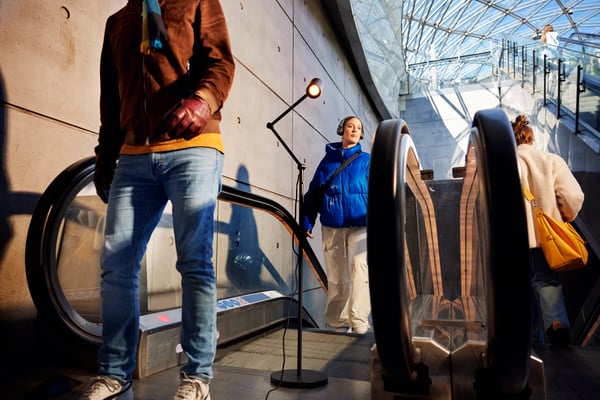 A floor lamp on the escalator. 