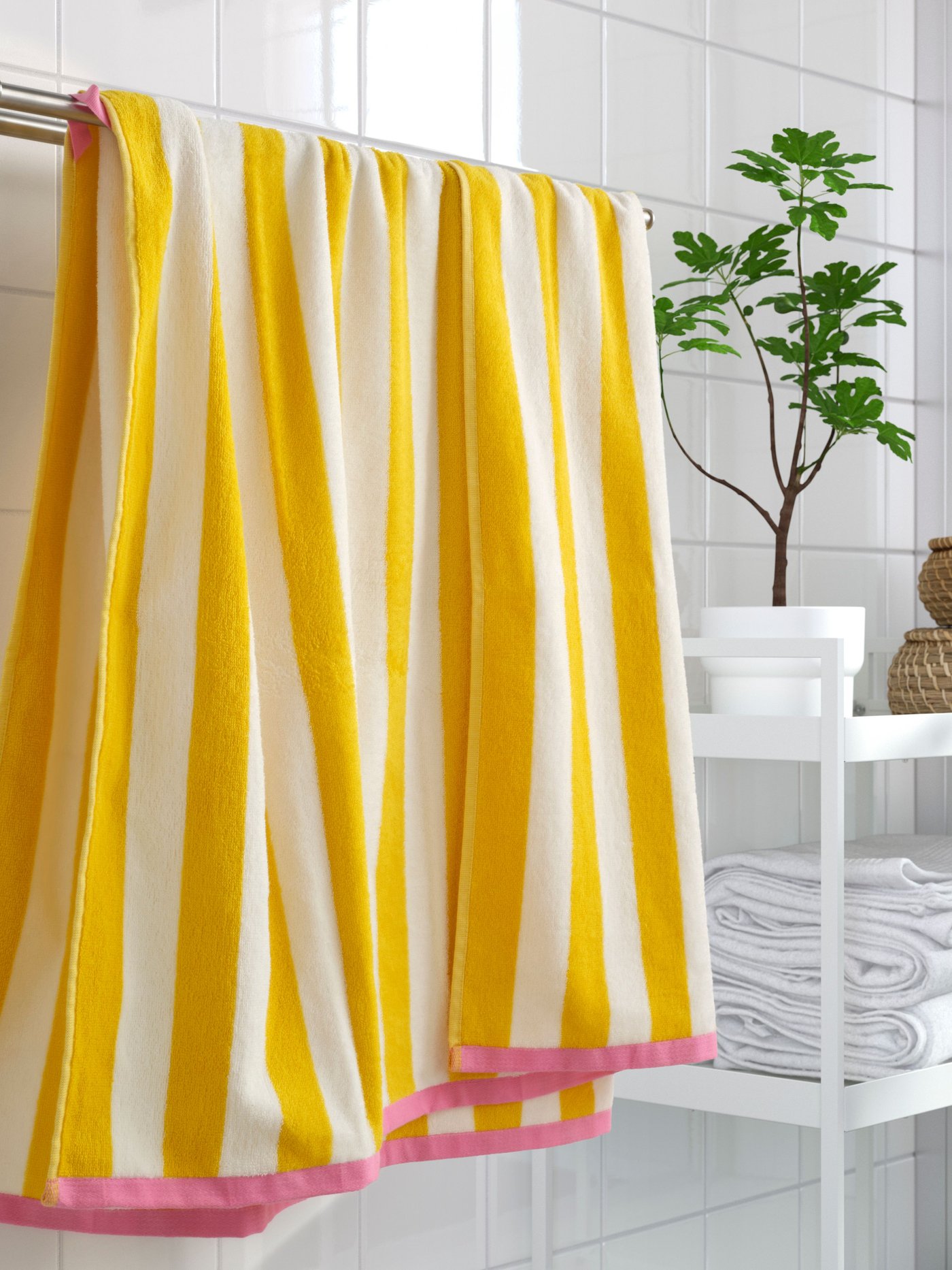 A white/yellow striped SLÅNHÖSTMAL bath sheet in the NA