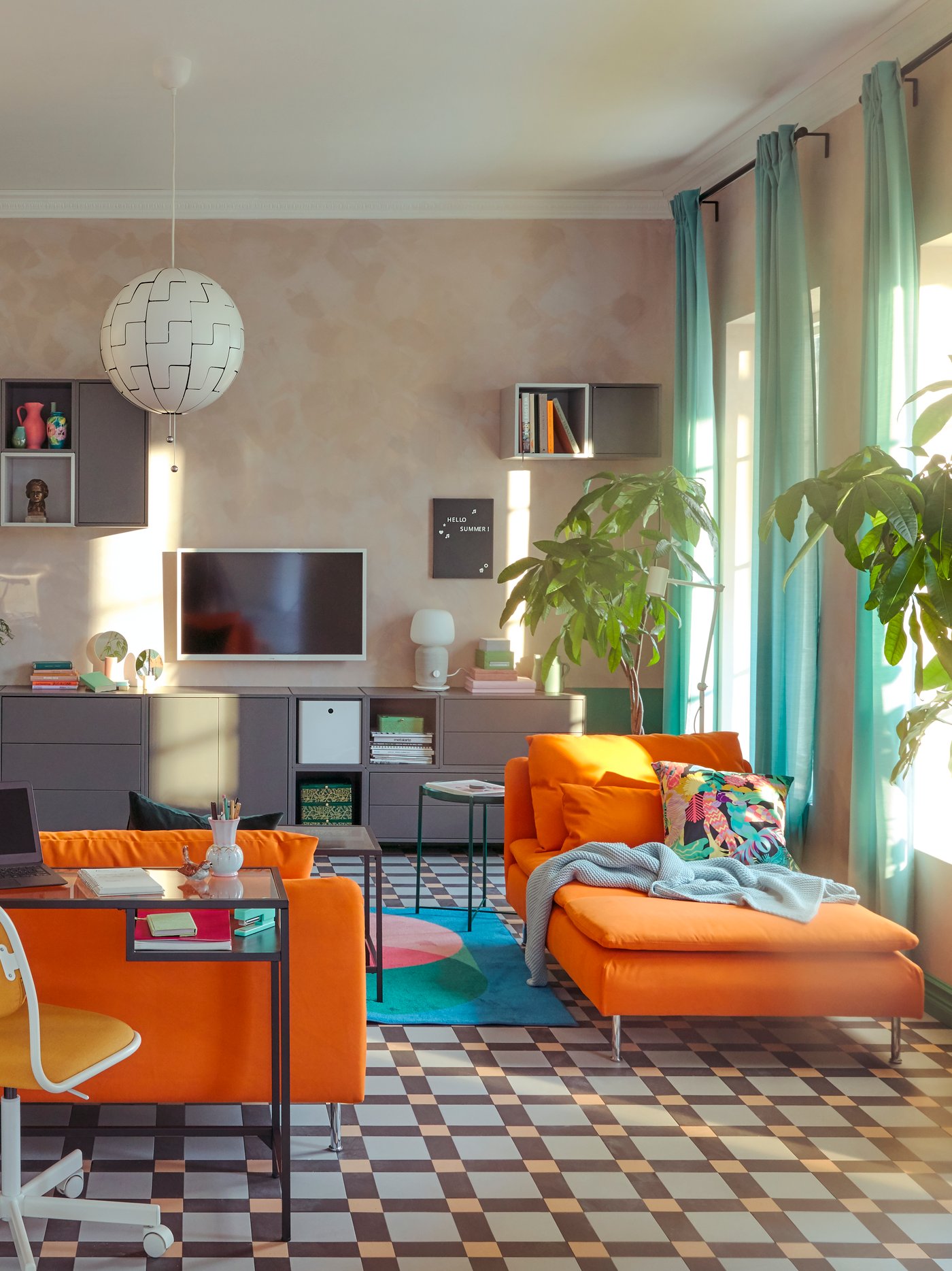 A living room with a scattered daytime arrangement of SÖDERHAMN seating and workspace with a VITTSJÖ laptop table.