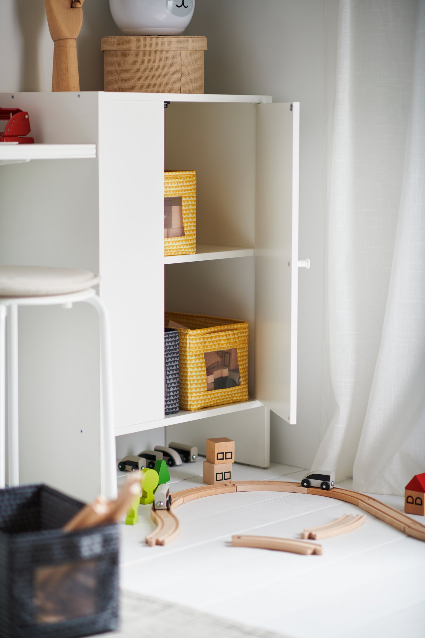 A beige KVARNVIK storage box in the childrens room