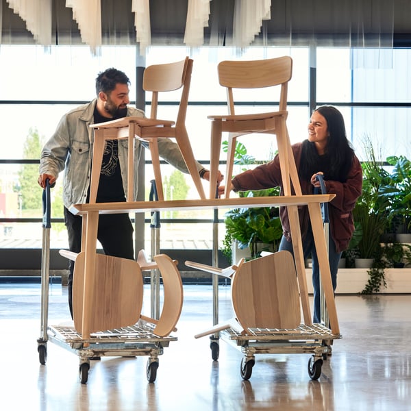 people moving furniture in a store