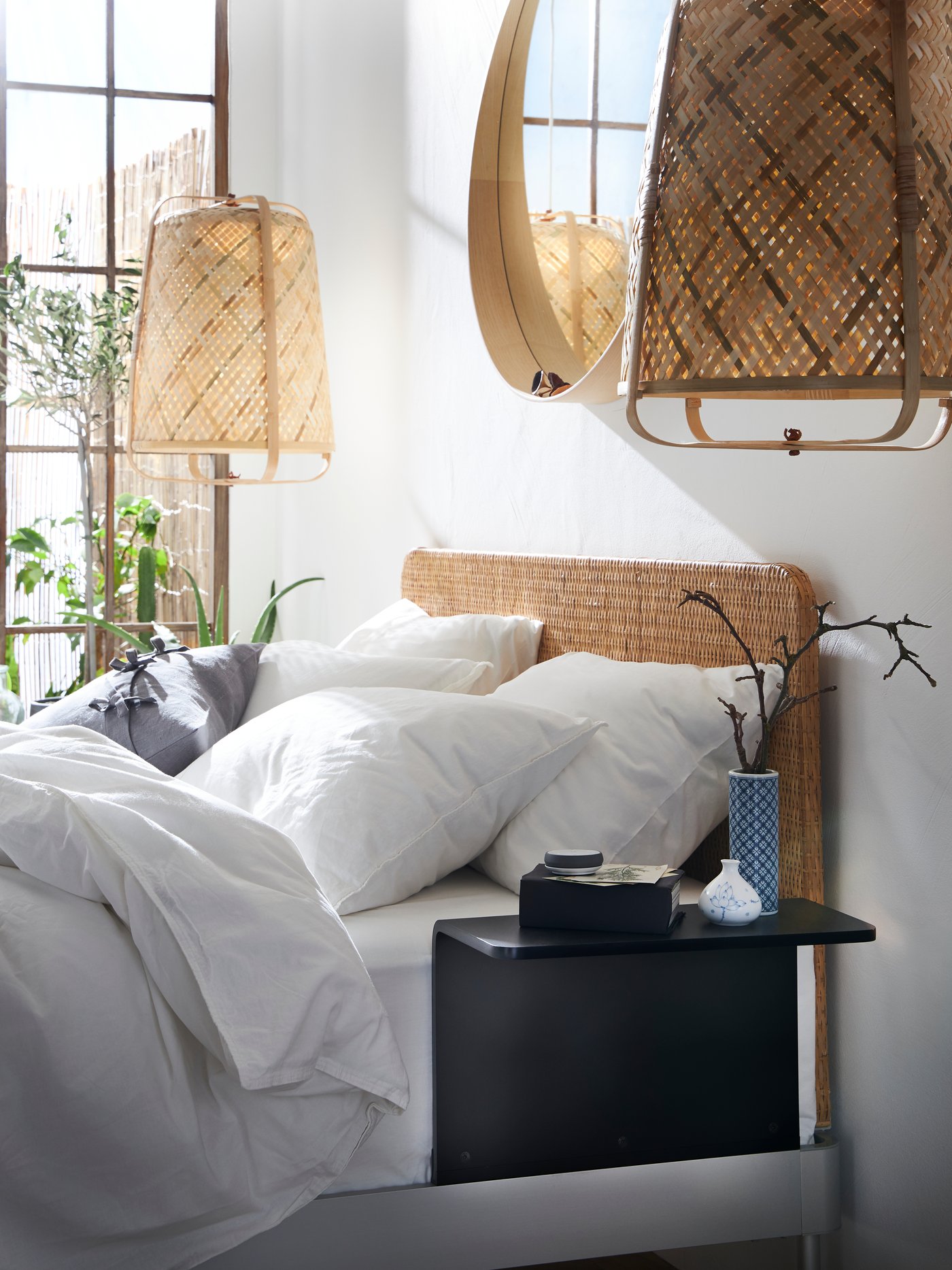 A bamboo/handmade KNIXHULT pendant lamp in the bedroom