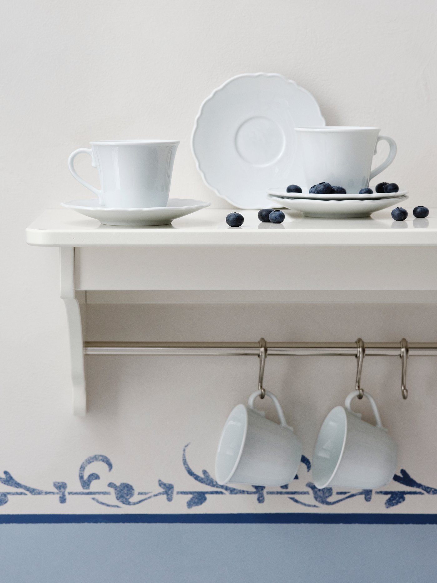 A white UPPLAGA cup with saucer