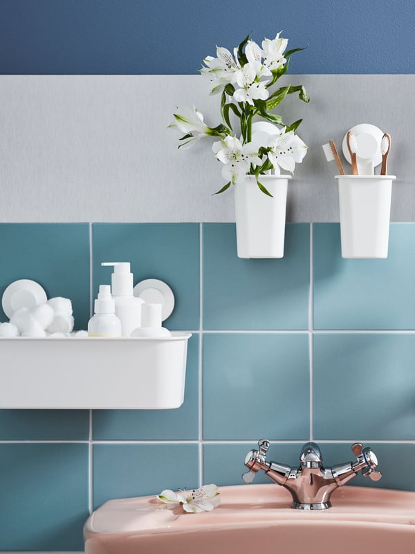 A white TISKEN basket with suction cup in the bathroom