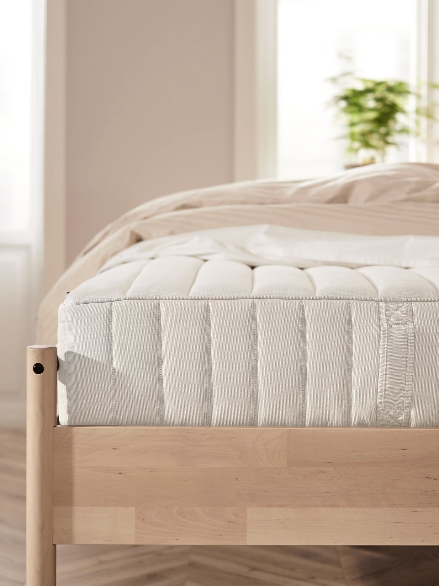 A firm/white VALEVÅG hybrid mattress