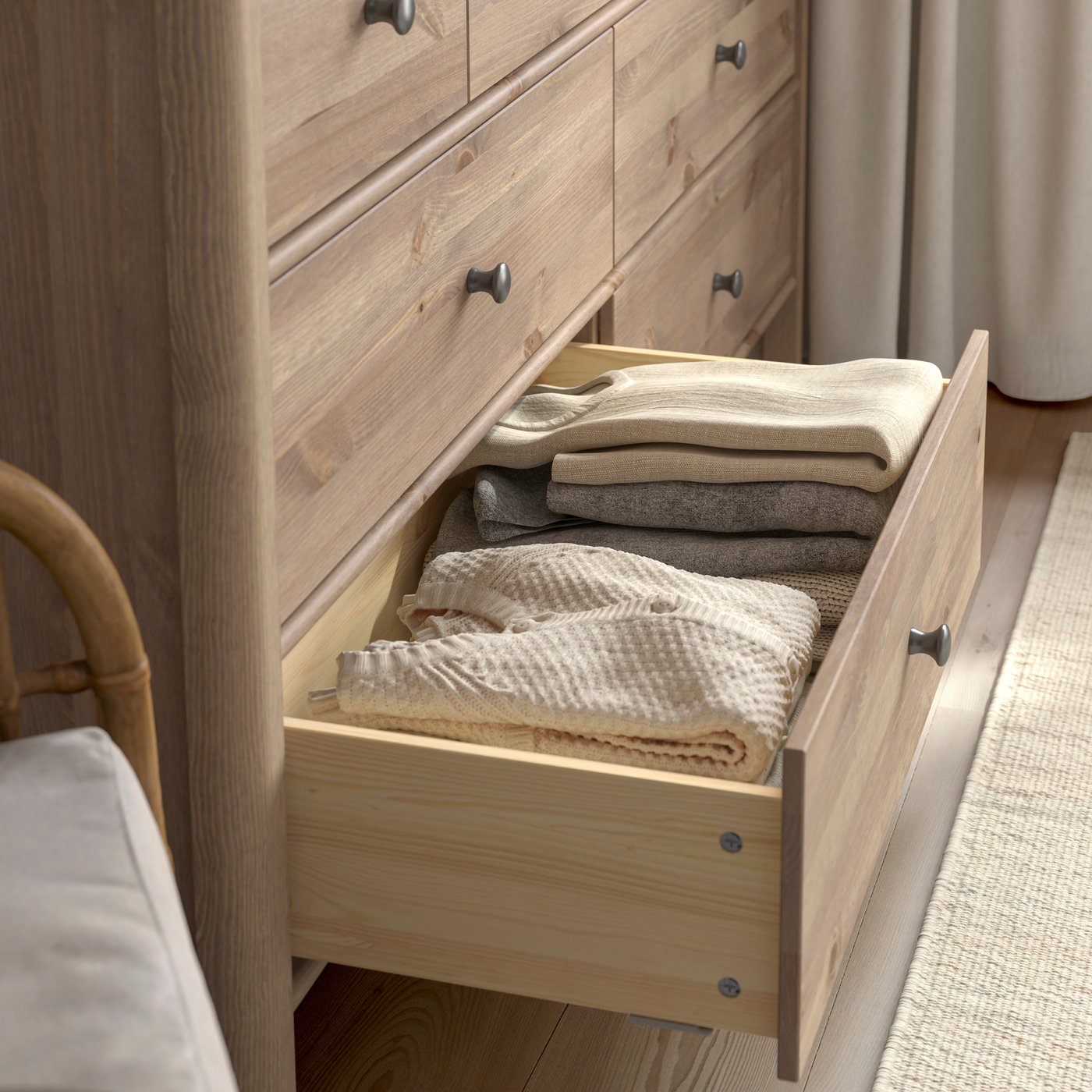 A grey-brown stained STOREMOLLA chest of 8 drawers in the bedroom