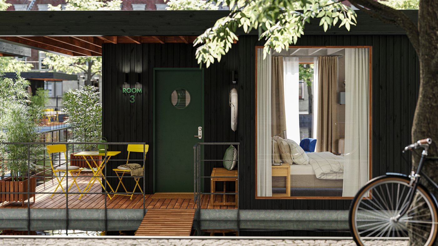 The deck of a small houseboat hotel floating on water in an urban context. One room with a bed can be seen through a window.