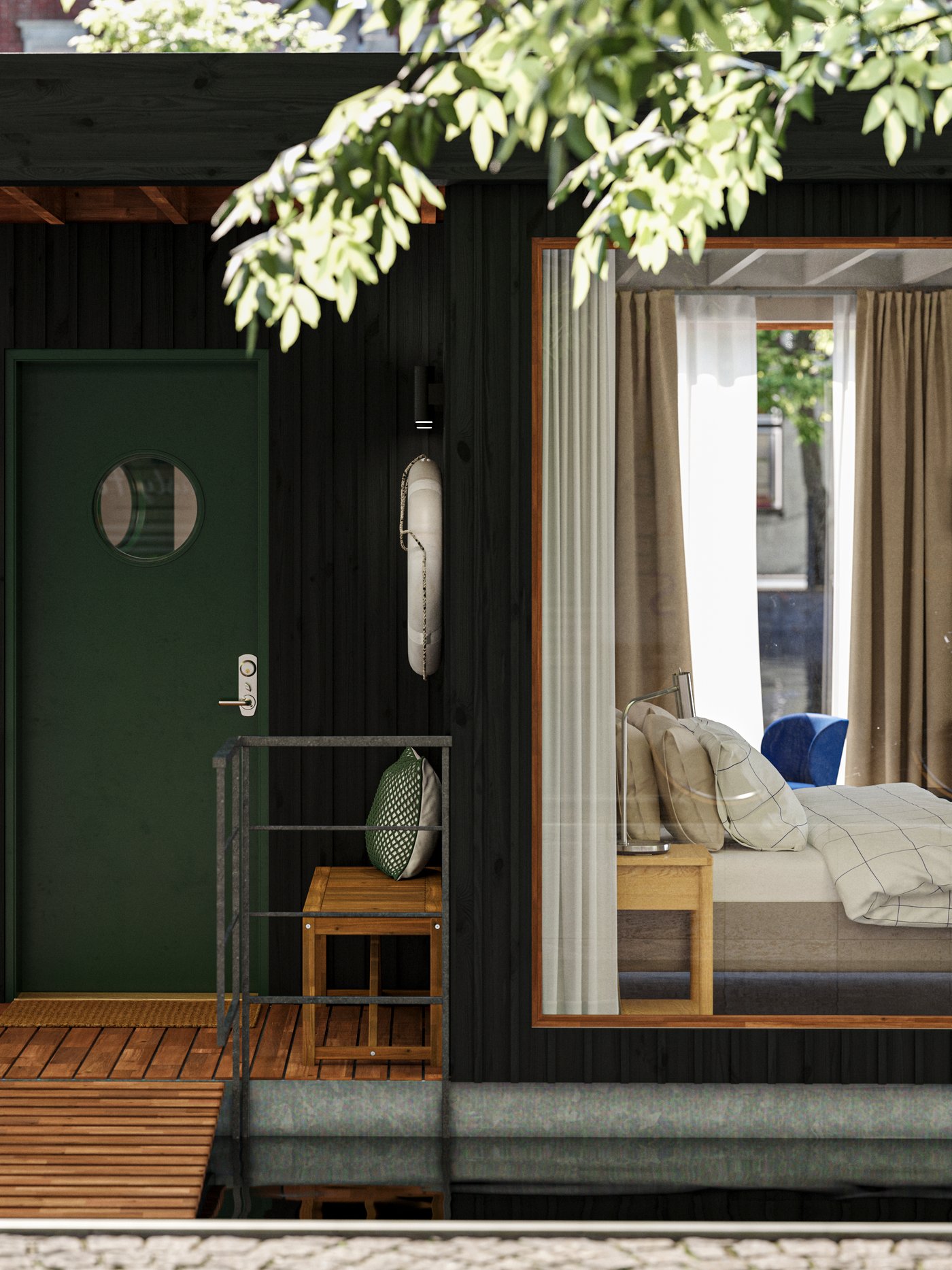 The deck of a small houseboat hotel floating on water in an urban context. One room with a bed can be seen through a window.