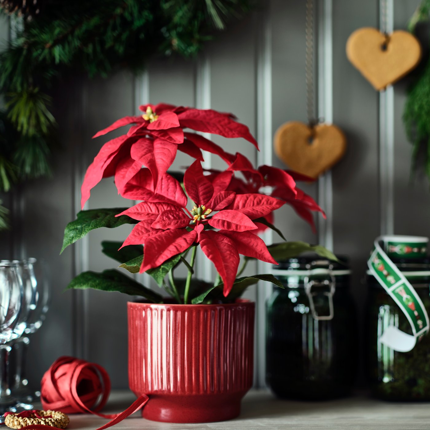 An in/outdoor Poinsettia/red VINTERFINT artificial potted plant