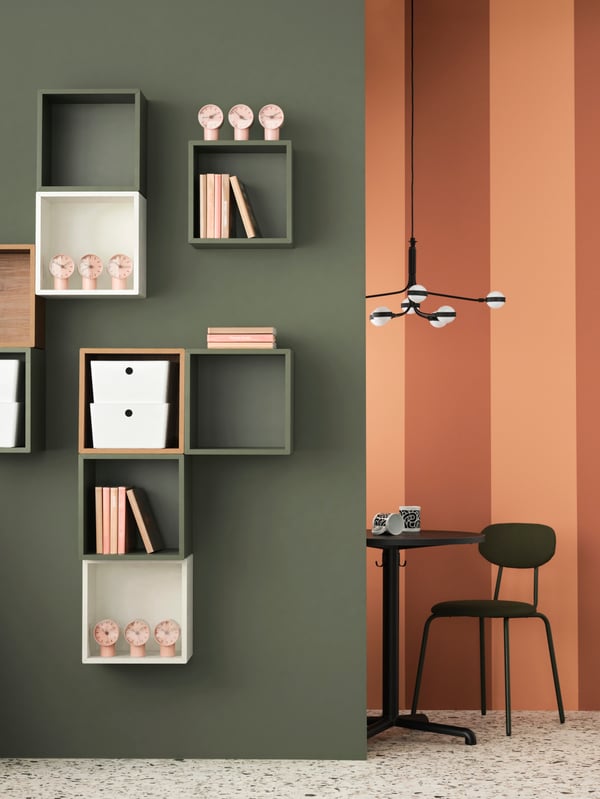 A grey-green EKET wall-mounted shelving unit