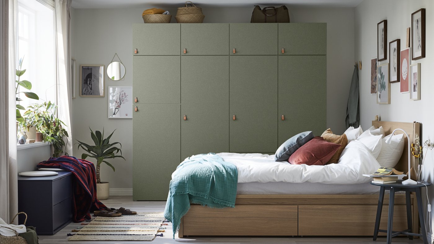 a bed with cushions and pillows